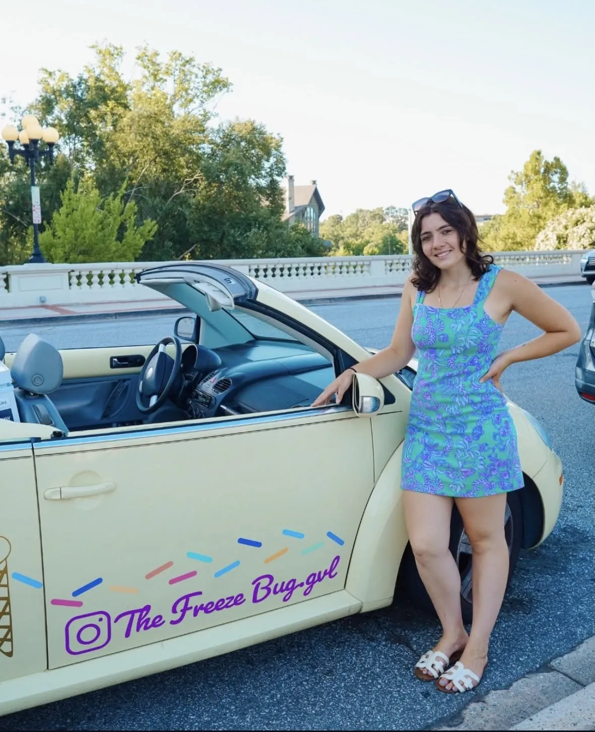 Helena standing beside the yellow Juno Buggy convertible
